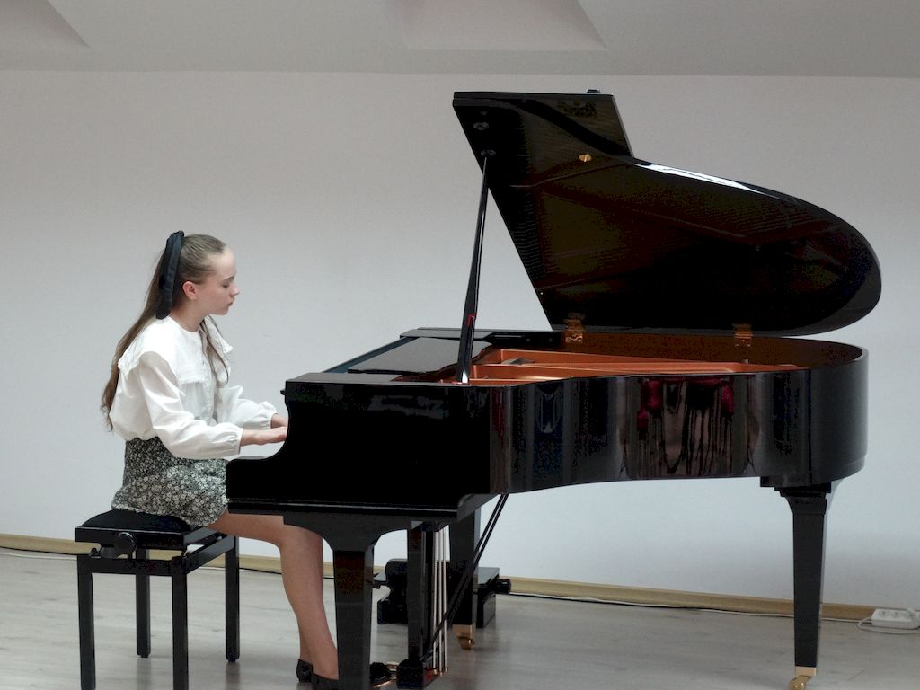 Uczennica grająca na fortepianie.