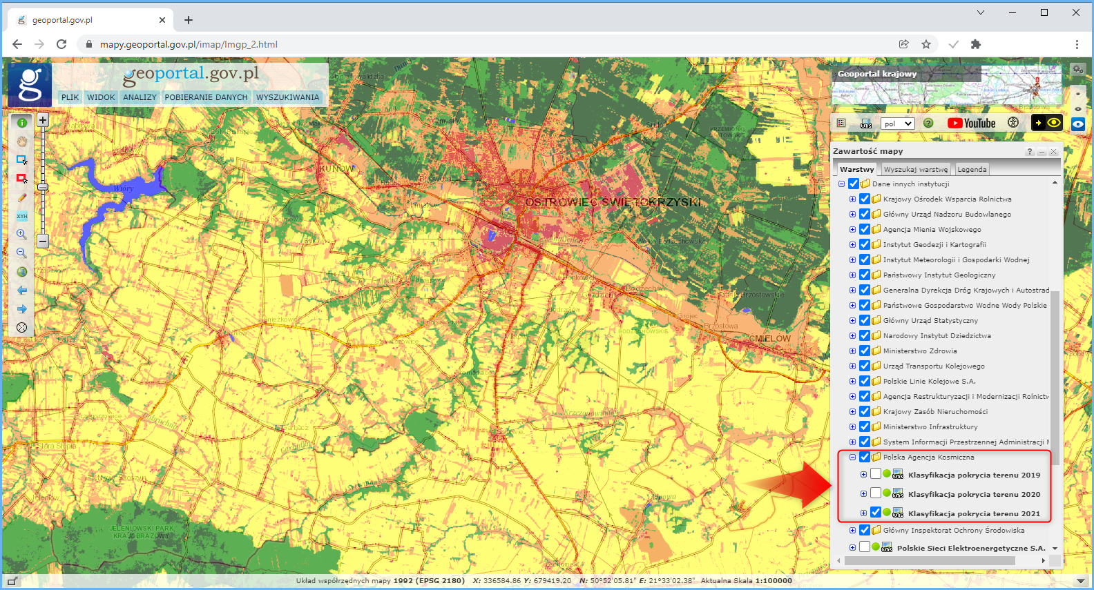 Ilustracja przestawia serwis mapowy geoportal.gov.pl wraz z widokiem na klasyfikację pokrycia terenu pochodzącym z warstwy o nazwie Klasyfikacja pokrycia terenu 2021 udostępnioną przez Polską Agencję Kosmiczną. 