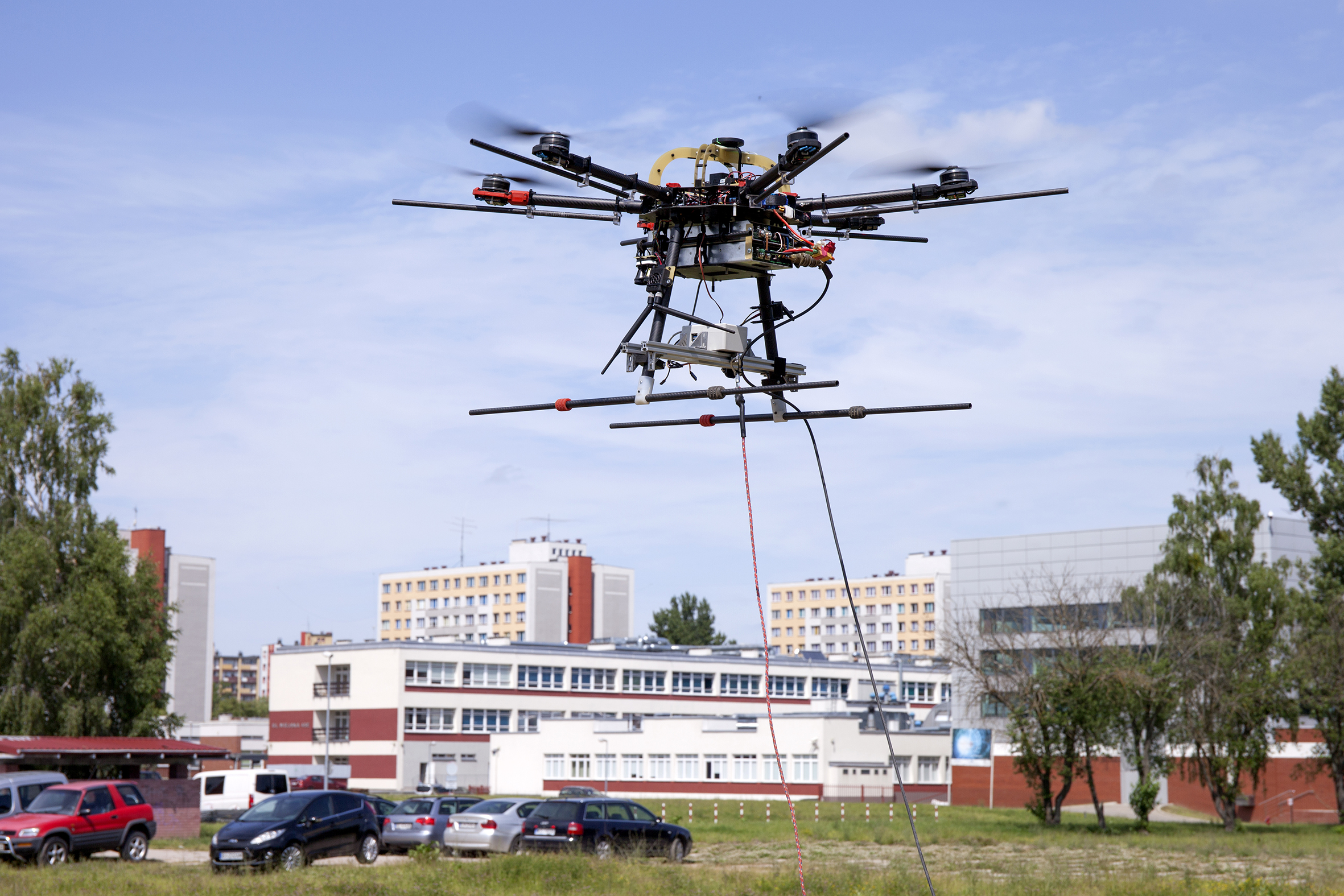 Tests of AVAL system components carried out at the Białystok University of Technology. In the center of the photo, you can see a drone rising above the meadow and a parking lot near the university campus