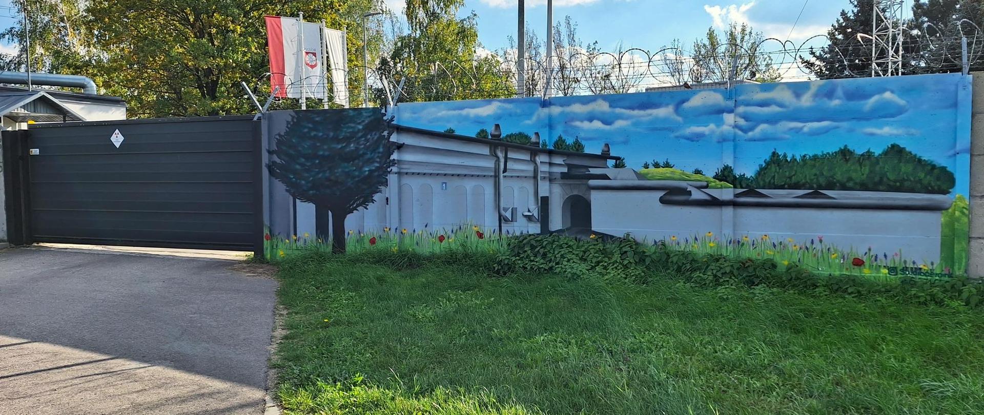 Mural przy bramie wjazdowej Krajowego Składowiska Odpadów Promieniotwórczych przedstawiający obiekt nr 1 KSOP