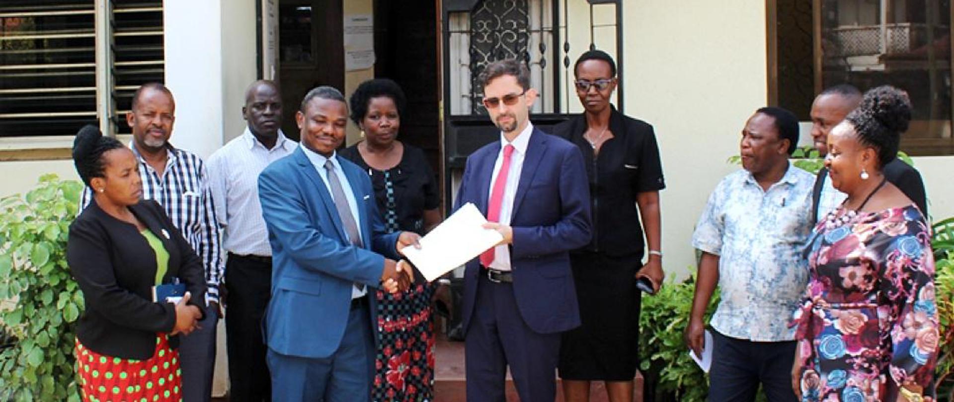 Amb. Buzalski receiving a diploma from Bakita