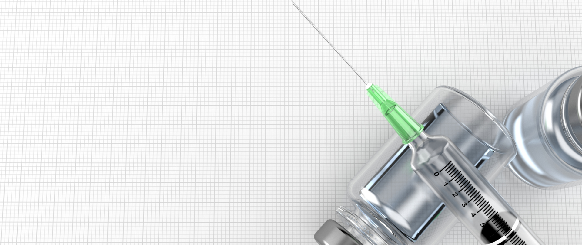 strzykawka a w tle pojemniczek ze szczepionką