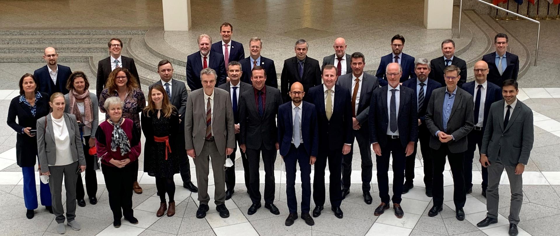 The participants of the WENRA meeting stand in a group in the foyer