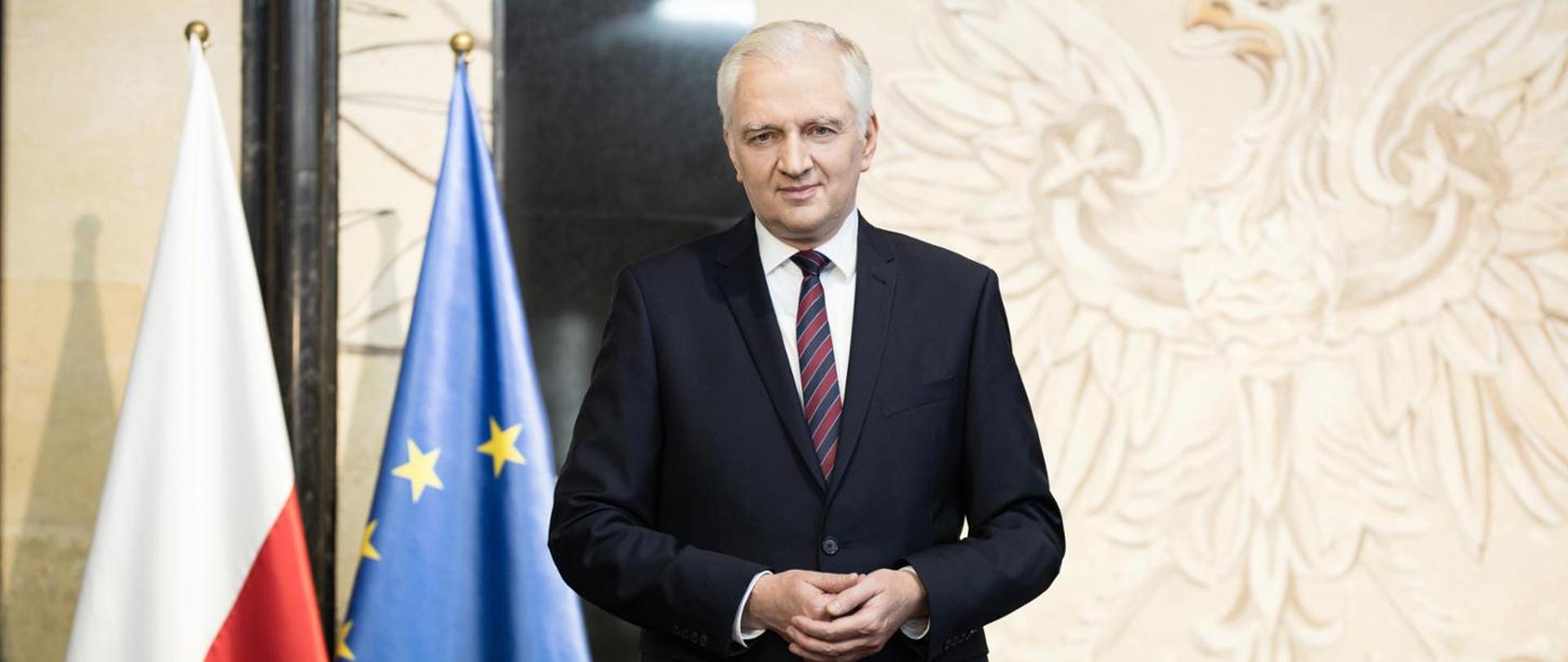 Prime Minister Jarosław Gowin by the Poland and EU flags