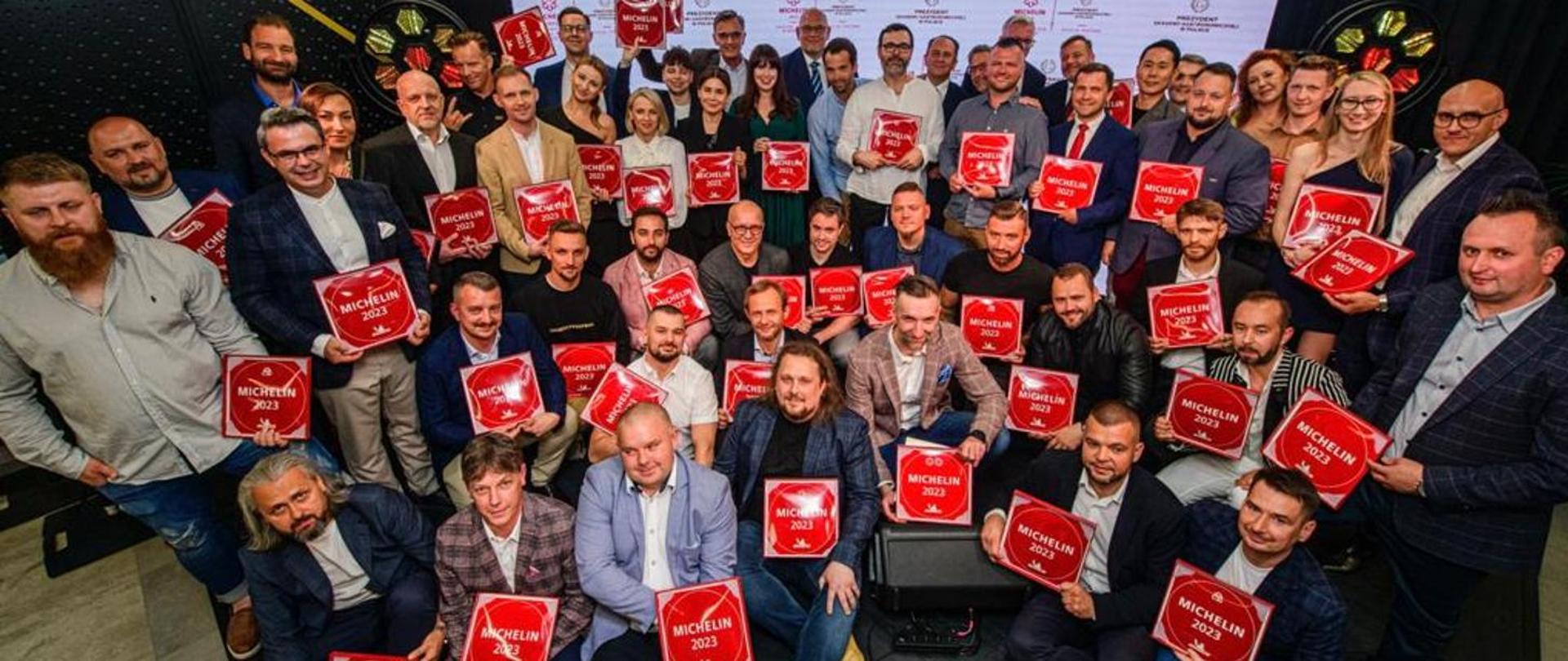 a group photo of owners of restaurants awarded with Michelin Plaques