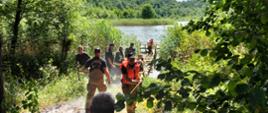 Ratownicy w czasie akcji ratowniczej w okolicach kładki nad jeziorem Bujackim