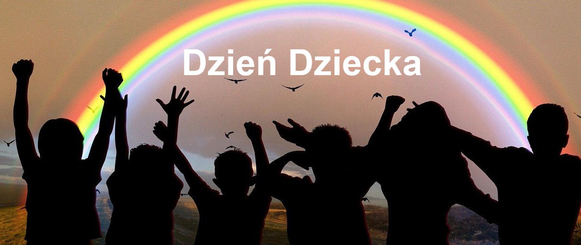 Na zdjęciu cienie dzieci, w tle ptaki, i tęcza. dzieci podnoszą ręce ku górze.