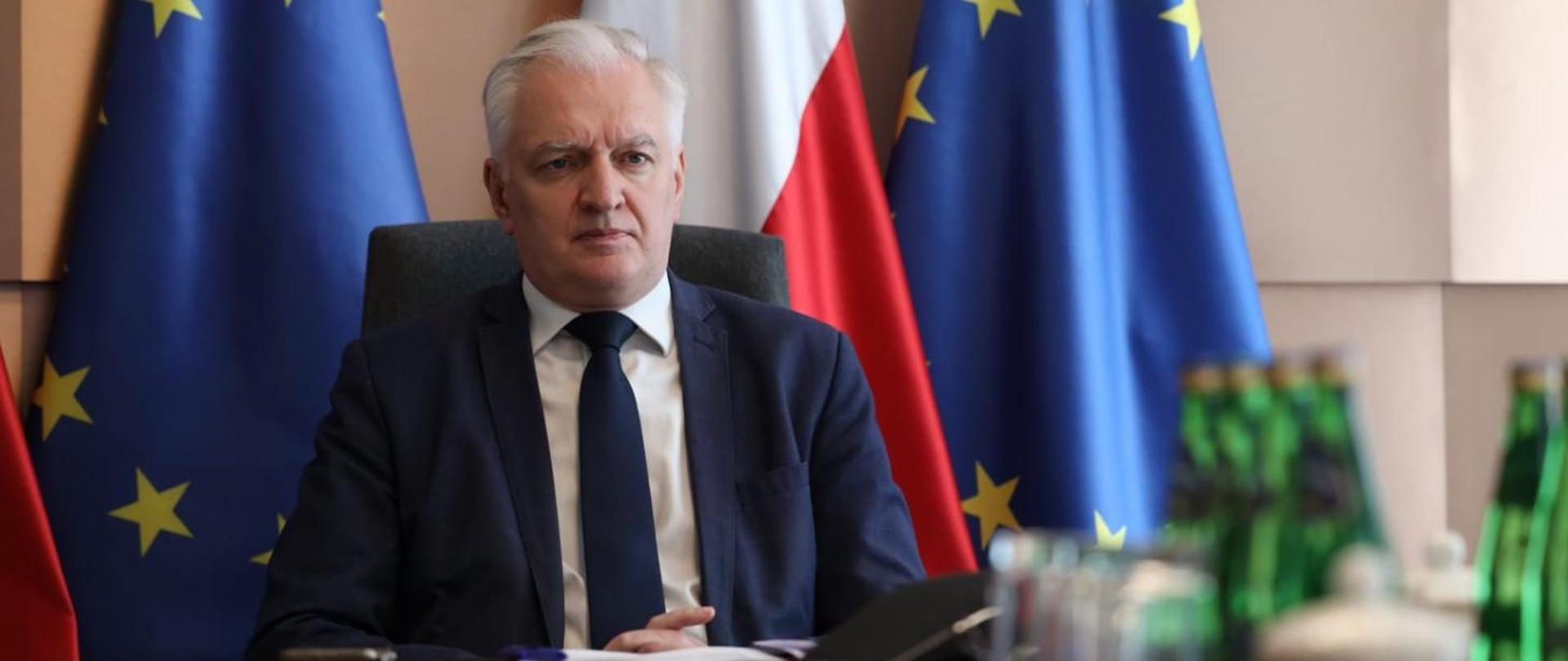 Deputy Prime Minister Jarosław Gowin at the meeting of economic ministers of the Berlin Process countries - Polish and EU flags in the background