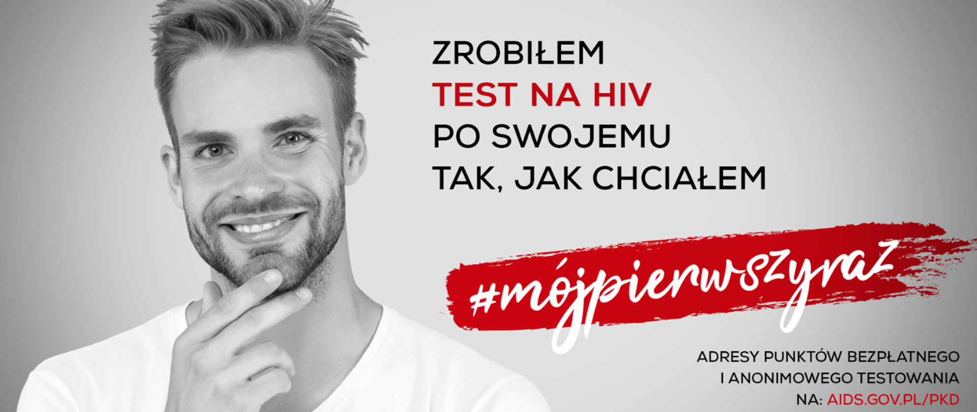 Grafika przedstawia uśmiechniętego młodego mężczyznę podtrzymującego podbródek. Obok napis: Zrobiłem test na HIV, Po swojemu. Tak, jak chciałem. #mójpierwszyraz Adresy punktów bezpłatnego testowania na: aids.gov.pl/pkd