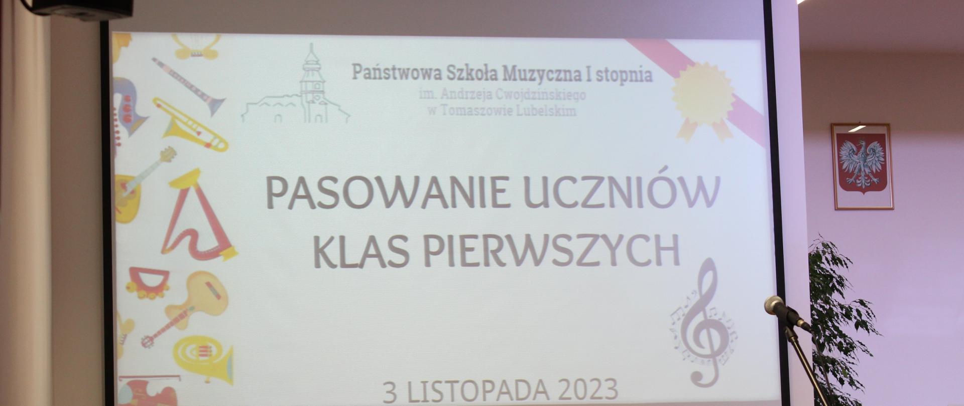 projektor z wyświetlonym plakatem na popis uczniów klas pierwszych