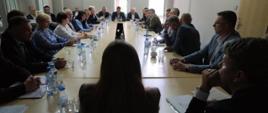 Minister funduszy funduszy i polityki regionalnej Katarzyna Pełczyńska-Nałęcz siedzi przy stole tyłem do obiektywu, przed nią siedzą samorządowcy