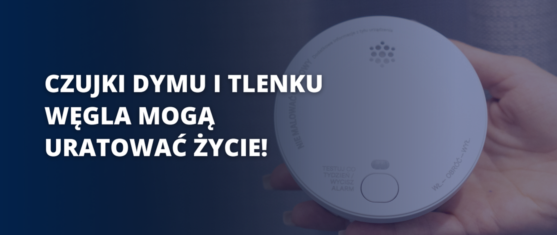 Na obrazie znajduje się dłoń trzymająca czujnik dymu i tlenku węgla. Po lewej stronie umieszczony jest napis w języku polskim: "CZUJKI DYMU I TLENKU WĘGLA MOGĄ URATOWAĆ ŻYCIE!". Tło jest ciemne, co podkreśla kontrast między tekstem a resztą grafiki. Czujnik jest biały, z widocznymi elementami, takimi jak kratka głośnika, przycisk testowy oraz napisy informacyjne. Obraz ma charakter edukacyjny i ostrzegawczy.