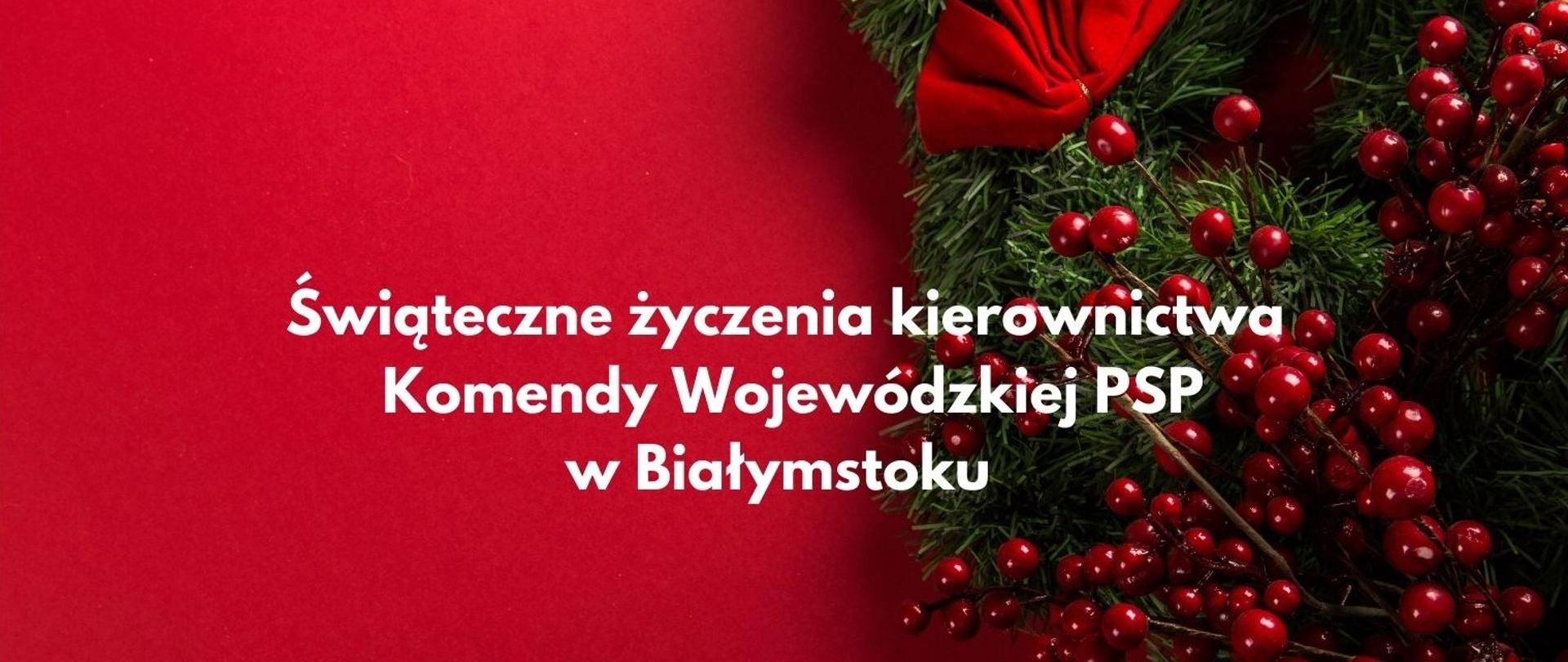 Życzenia świąteczne - biały napis na czerwonym tle, obok po prawej stronie gałązka jemioły