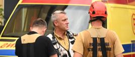 Dowódca akcji przekazuje polecenia strażakom na terenie akcji