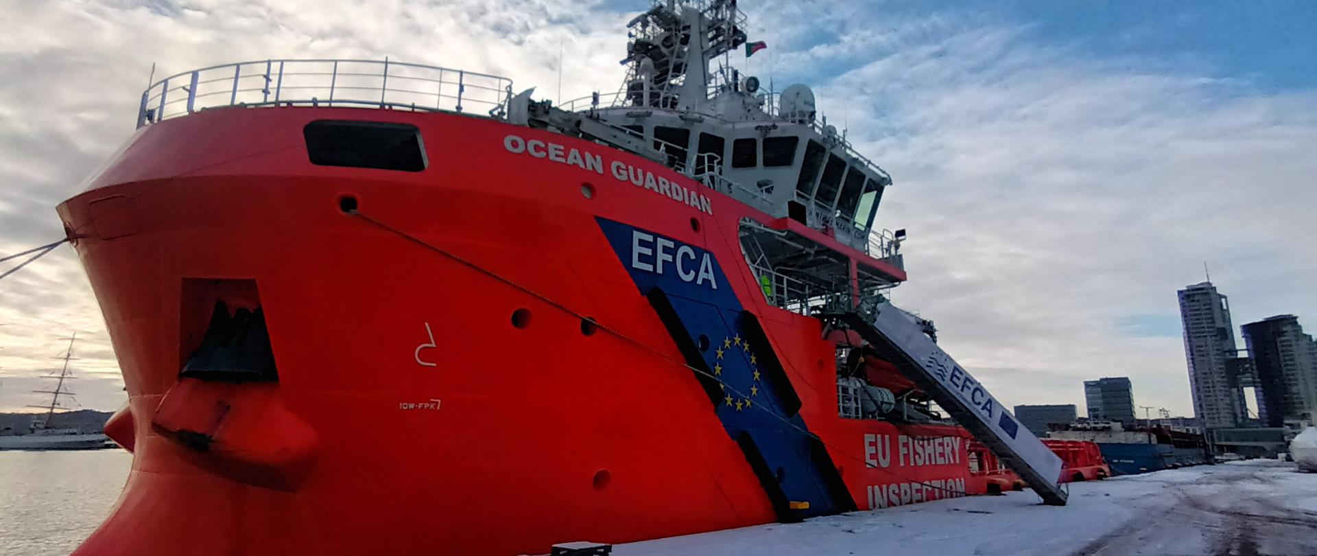 Pomarańczowy statek kontrolny Ocean Guardian Europejskiej Agencji Kontroli Rybołówstwa , logo Agencji widoczne na burcie, zacumowany w porcie Gdynia