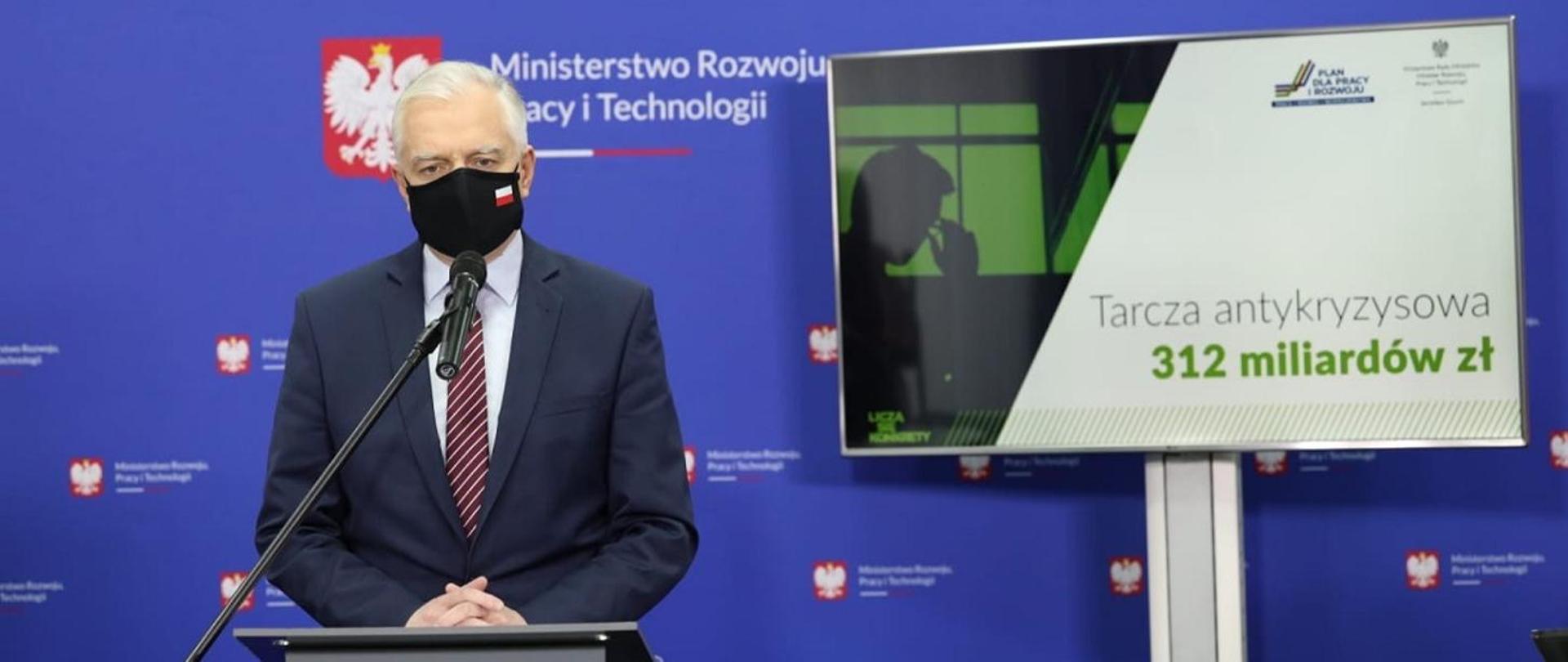 Deputy Prime Minister Jarosław Gowin and financial shield graphic