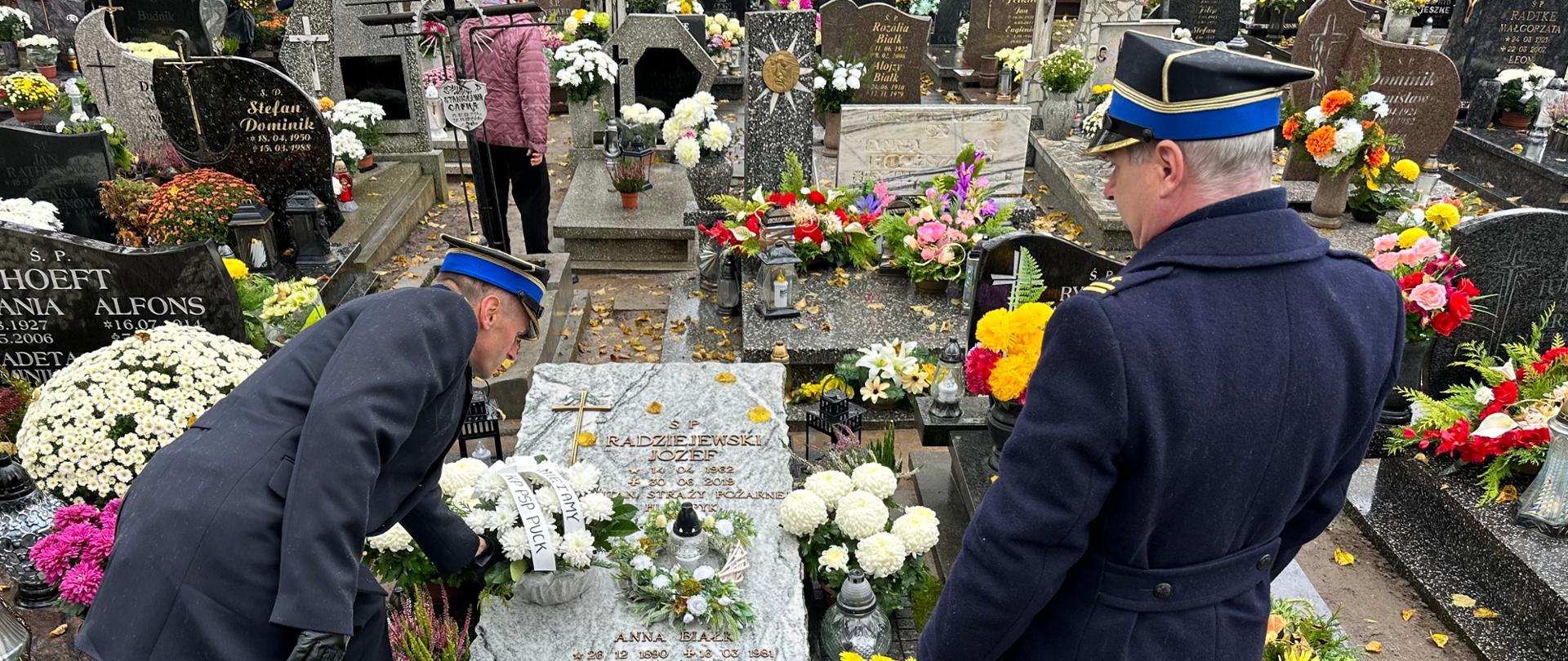 Komendanci składają kwiaty na grobach zmarłych 